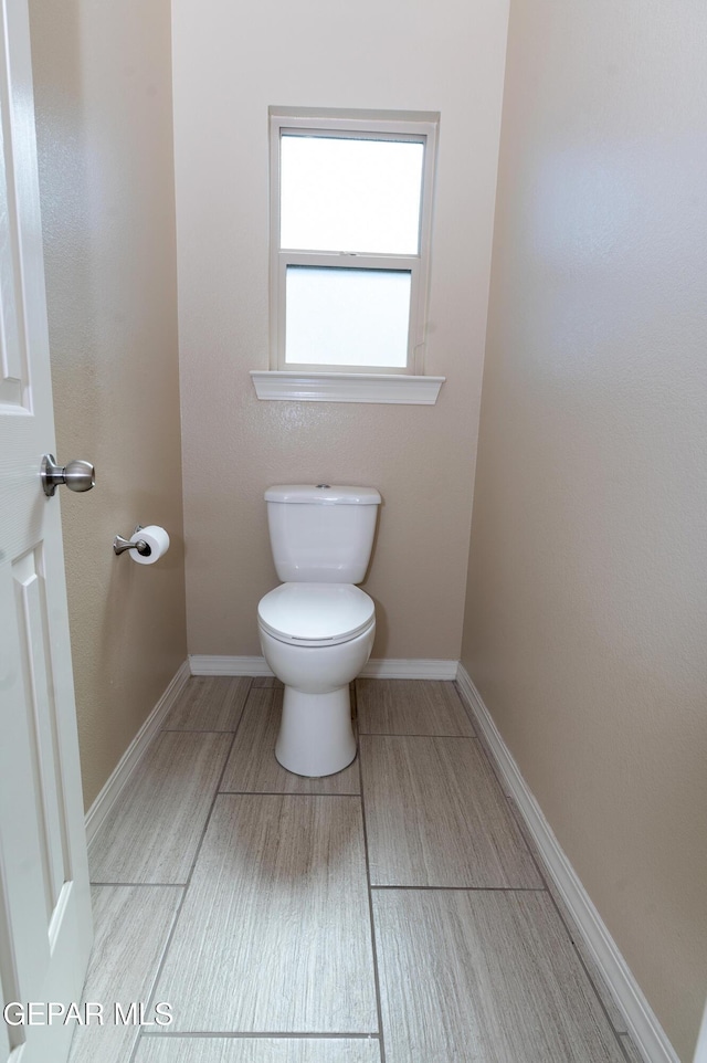 14700 Alton Oaks, El Paso, TX 79938 - bathroom with toilet, baseboards, and wood finished floors