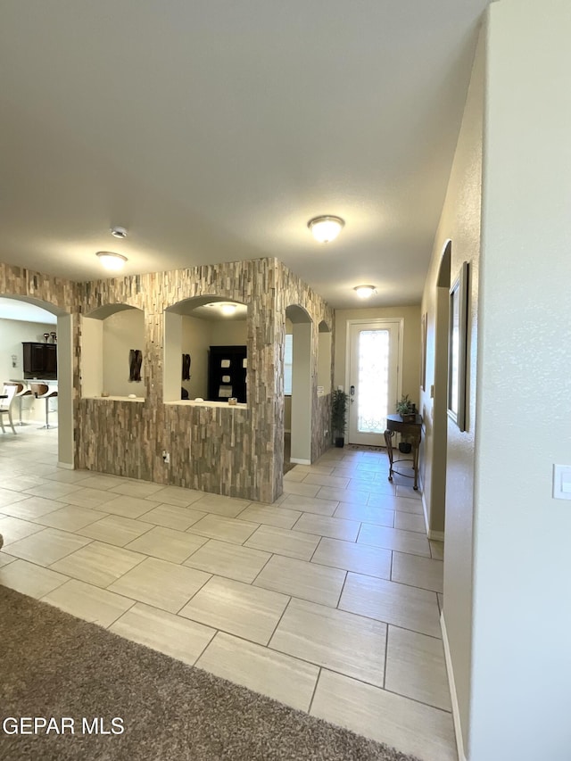 14700 Alton Oaks, El Paso, TX 79938 - hallway with arched walkways and light tile patterned floors