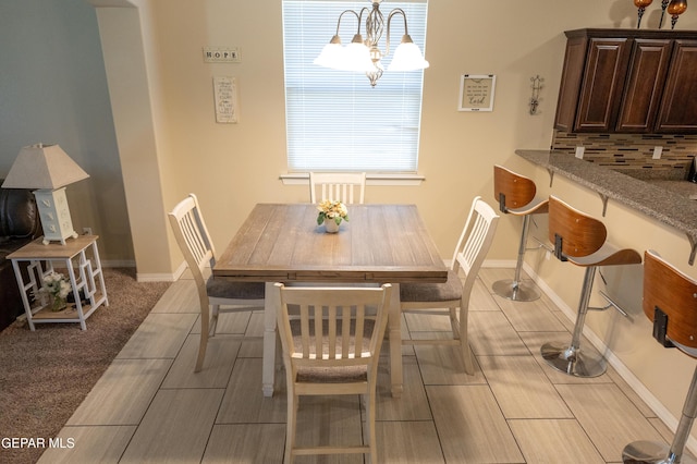 14700 Alton Oaks, El Paso, TX 79938 - dining area with baseboards and a notable chandelier