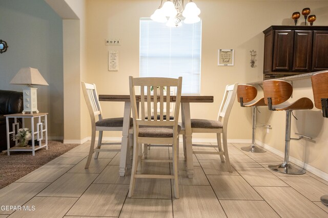 14700 Alton Oaks, El Paso, TX 79938 - dining room with a chandelier, baseboards, and light wood-style flooring