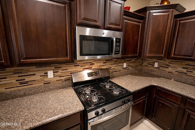 14700 Alton Oaks, El Paso, TX 79938 - kitchen featuring dark brown cabinets, stainless steel appliances, and tasteful backsplash