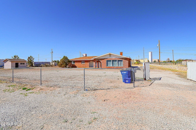 9668 Kathy Ave, El Paso, TX 79927 - view of front facade with brick siding, fence, and a chimney