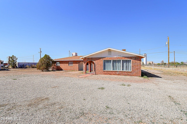 9668 Kathy Ave, El Paso, TX 79927 - view of front facade featuring a chimney and brick siding
