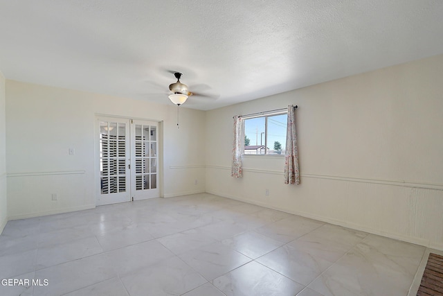 9668 Kathy Ave, El Paso, TX 79927 - unfurnished room with a ceiling fan, baseboards, and french doors