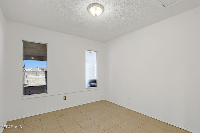 9668 Kathy Ave, El Paso, TX 79927 - spare room with baseboards, a textured ceiling, and light tile patterned floors