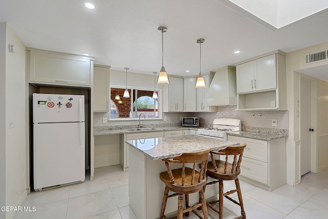 9668 Kathy Ave, El Paso, TX 79927 - kitchen with a sink, tasteful backsplash, visible vents, white appliances, and custom range hood