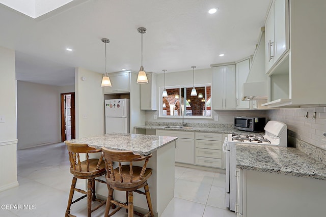 9668 Kathy Ave, El Paso, TX 79927 - kitchen featuring a sink, tasteful backsplash, white appliances, light stone counters, and custom range hood