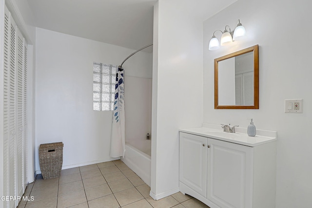 9668 Kathy Ave, El Paso, TX 79927 - full bathroom featuring tile patterned floors, baseboards, a closet, shower / bathtub combination with curtain, and vanity