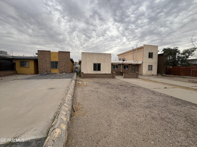 property in mid-construction featuring stucco siding and fence