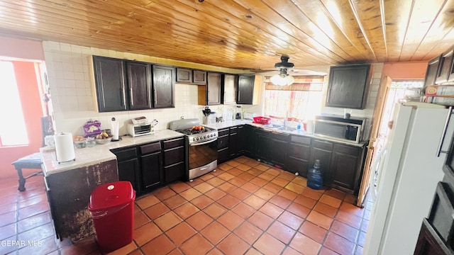 610 Jewels Dr, Socorro, TX 79927 - kitchen featuring tile patterned flooring, wooden ceiling, a sink, decorative backsplash, and appliances with stainless steel finishes