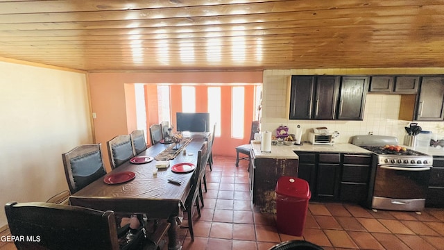 610 Jewels Dr, Socorro, TX 79927 - kitchen with wooden ceiling, tasteful backsplash, stainless steel gas range, tile patterned flooring, and light countertops