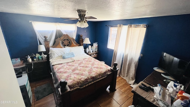 610 Jewels Dr, Socorro, TX 79927 - bedroom with wood finished floors, a textured ceiling, and a ceiling fan