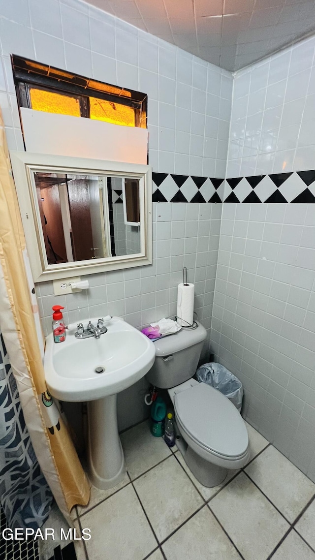 610 Jewels Dr, Socorro, TX 79927 - bathroom with tile walls, tile patterned floors, and toilet