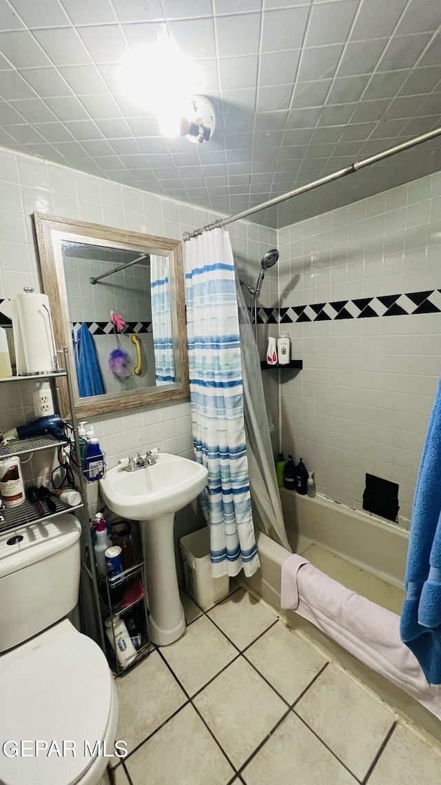 610 Jewels Dr, Socorro, TX 79927 - bathroom with tile walls, tile patterned flooring, shower / bath combo, and toilet