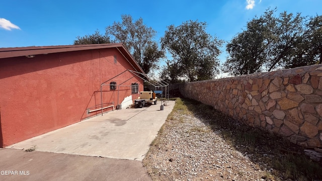 610 Jewels Dr, Socorro, TX 79927 - view of property exterior with stucco siding, a patio, and fence
