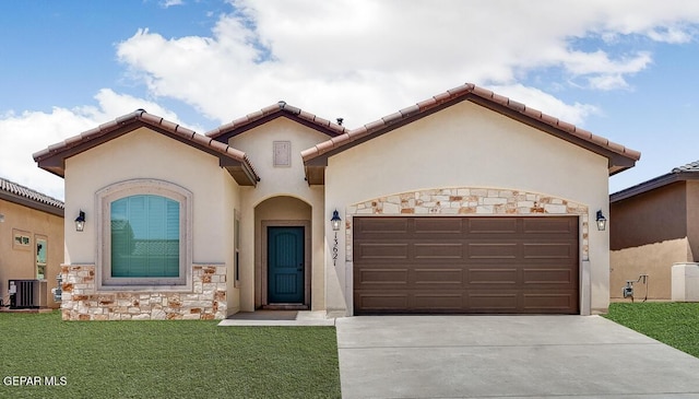 11969 Medalla St, Socorro, TX 79927 - mediterranean / spanish home featuring central AC, stucco siding, driveway, stone siding, and a front yard