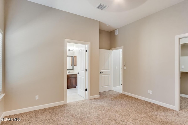 11969 Medalla St, Socorro, TX 79927 - unfurnished bedroom featuring baseboards, visible vents, a spacious closet, and light colored carpet