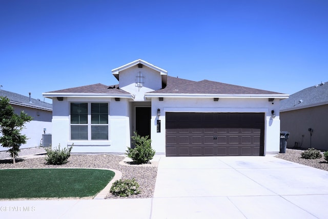 1628 Sam Dominguez, El Paso, TX 79928 - view of front of property featuring an attached garage, concrete driveway, cooling unit, and stucco siding