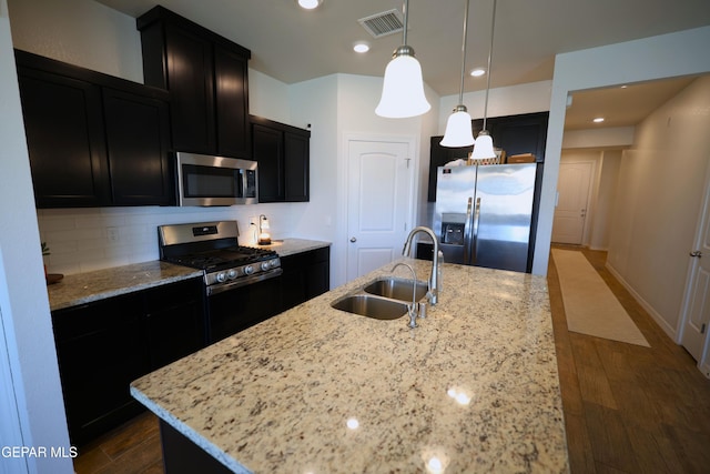 1628 Sam Dominguez, El Paso, TX 79928 - kitchen with stainless steel appliances, a sink, dark wood-style flooring, visible vents, and dark cabinets