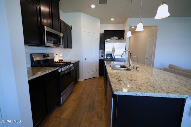 1628 Sam Dominguez, El Paso, TX 79928 - kitchen featuring dark wood-style flooring, a sink, appliances with stainless steel finishes, a center island with sink, and dark cabinets