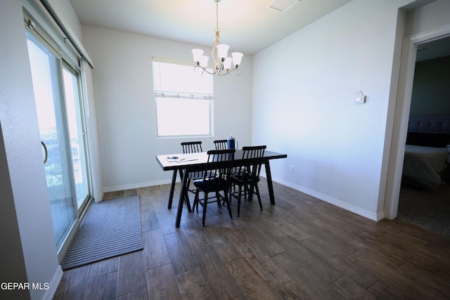 1628 Sam Dominguez, El Paso, TX 79928 - dining area featuring dark wood-type flooring, baseboards, and an inviting chandelier