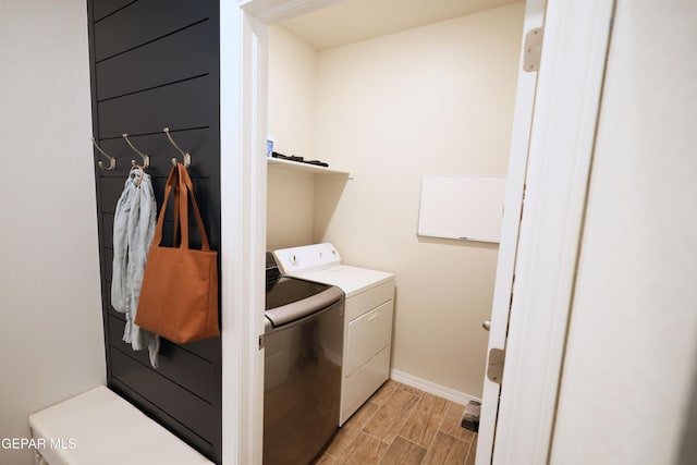 1628 Sam Dominguez, El Paso, TX 79928 - laundry room with wood finish floors, washer and clothes dryer, laundry area, and baseboards