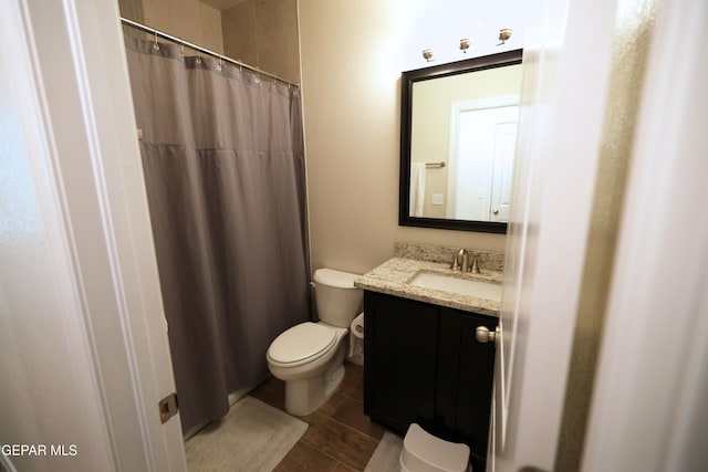 1628 Sam Dominguez, El Paso, TX 79928 - bathroom with wood finished floors, vanity, a shower with shower curtain, and toilet