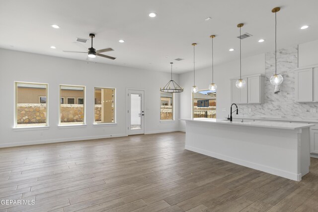 3780 Surmise St, El Paso, TX 79938 - unfurnished living room with ceiling fan, recessed lighting, wood finished floors, a sink, and baseboards