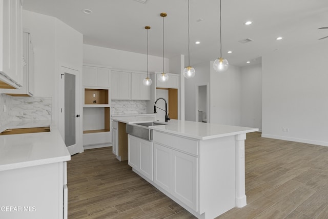 3780 Surmise St, El Paso, TX 79938 - kitchen featuring a sink, backsplash, an island with sink, light wood-type flooring, and recessed lighting