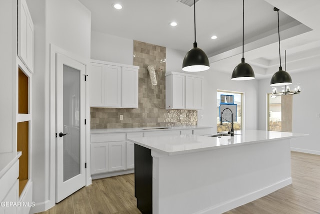 3749 Focus Pl, El Paso, TX 79938 - kitchen with tasteful backsplash, recessed lighting, light countertops, light wood-style floors, and electric cooktop