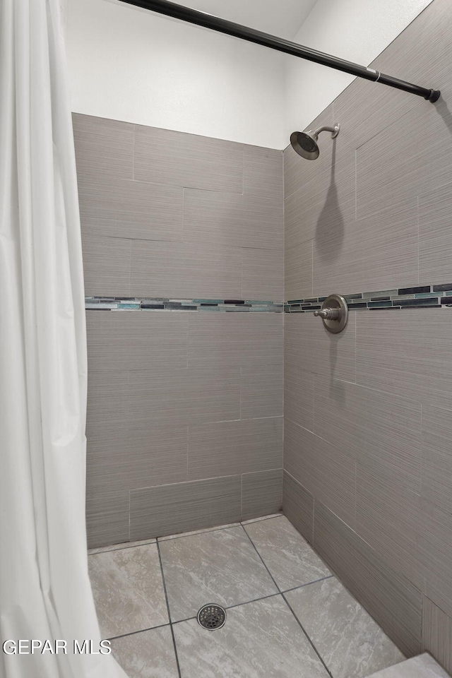 bathroom with tiled shower