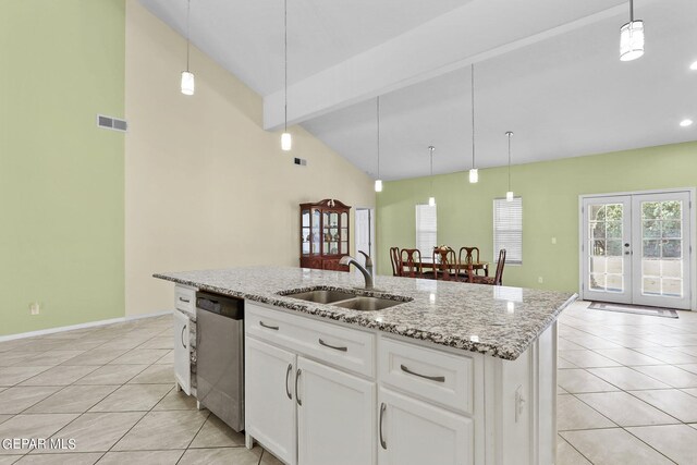 kitchen with dishwasher, light tile patterned flooring, a sink, and hanging light fixtures