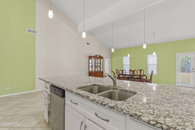 kitchen featuring white cabinets, stainless steel dishwasher, beam ceiling, and a sink