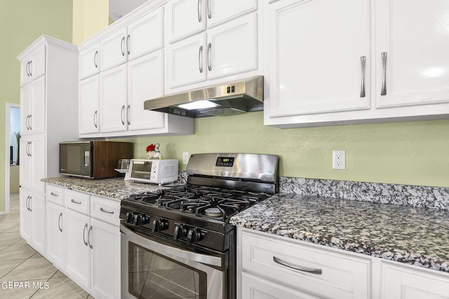 kitchen featuring white cabinets, under cabinet range hood, gas stove, and a toaster