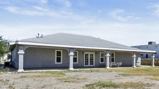 back of property with french doors and stucco siding