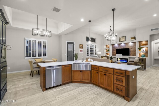 kitchen with a sink, visible vents, a notable chandelier, and dishwasher
