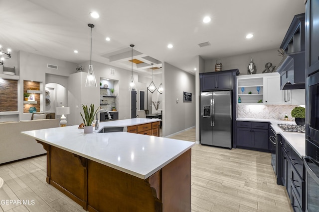 kitchen with open shelves, light wood-style floors, a sink, appliances with stainless steel finishes, and backsplash