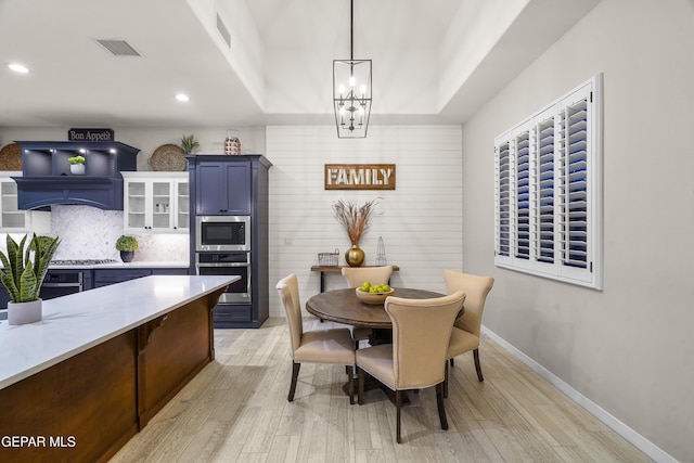 dining space with recessed lighting, visible vents, an inviting chandelier, and light wood-type flooring