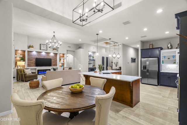 dining room featuring light wood-style floors, visible vents, recessed lighting, and a chandelier