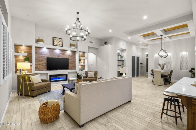 living area featuring visible vents, light wood finished floors, an inviting chandelier, coffered ceiling, and recessed lighting