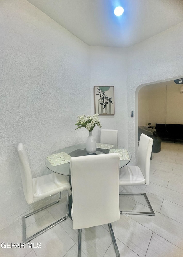 dining area with arched walkways
