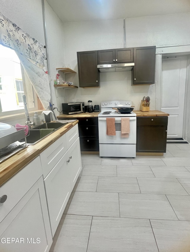 kitchen featuring wood counters, under cabinet range hood, white range with electric cooktop, and stainless steel microwave