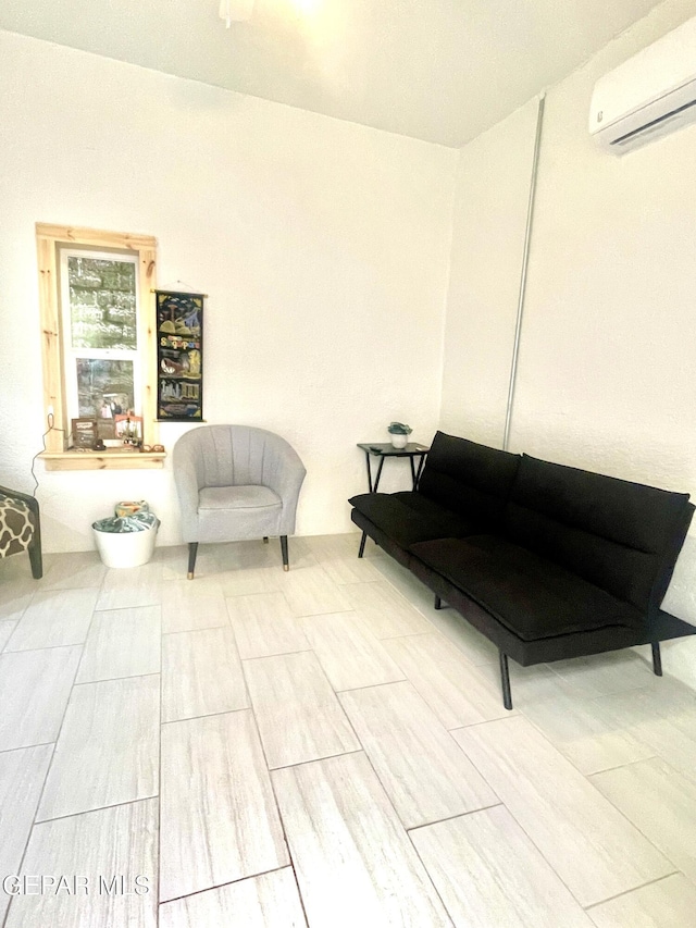 living area with wood finished floors and a wall unit AC