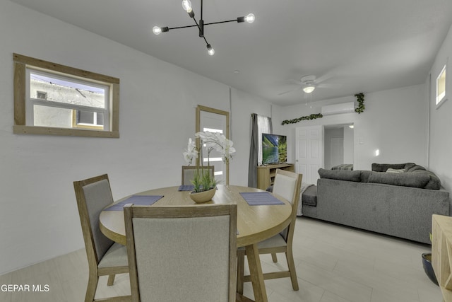 dining room featuring a wall mounted AC and ceiling fan with notable chandelier