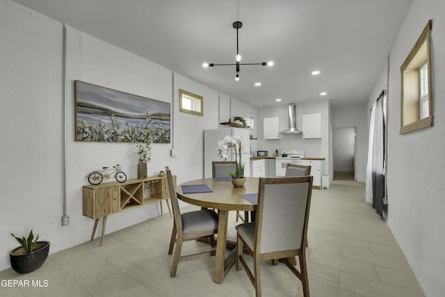 dining area with light floors, recessed lighting, and a chandelier