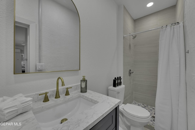 full bath featuring recessed lighting, a shower stall, a textured wall, toilet, and vanity