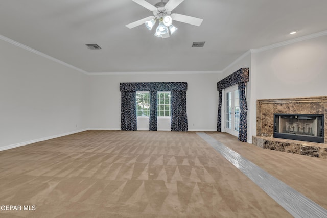 unfurnished living room featuring light colored carpet, ornamental molding, visible vents, and a fireplace