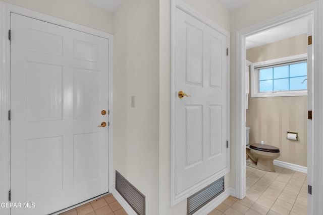 interior space with light tile patterned flooring, baseboards, and visible vents