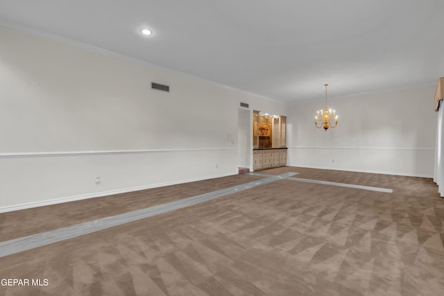 carpeted empty room with a chandelier, recessed lighting, baseboards, visible vents, and ornamental molding