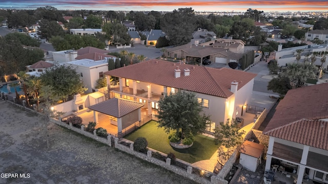 aerial view at dusk featuring a residential view